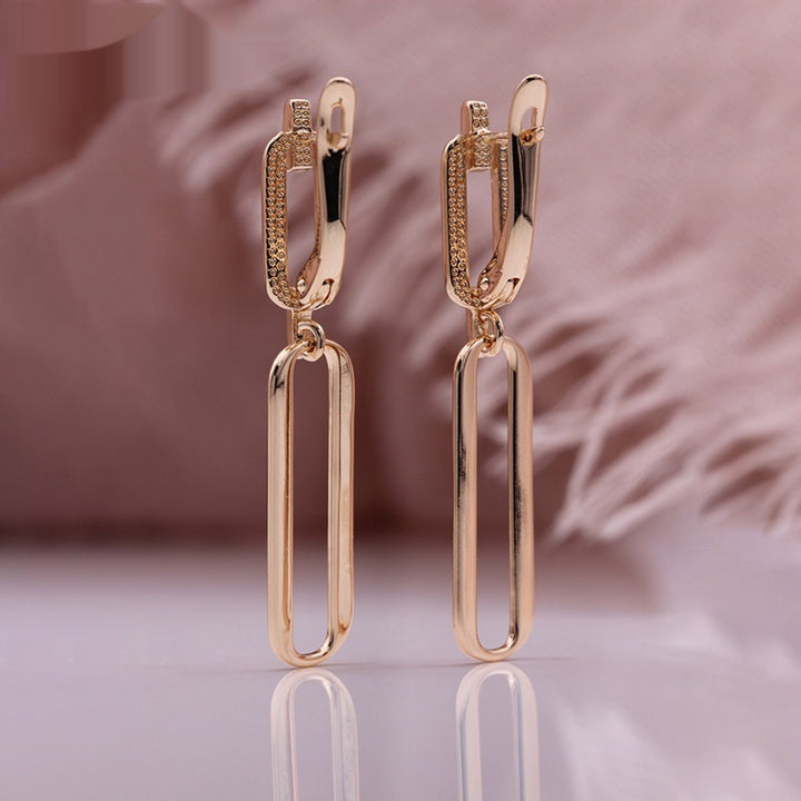 Boucles d'oreilles longues pendantes creuses en or rose avec micro-incrustations de zircons naturels